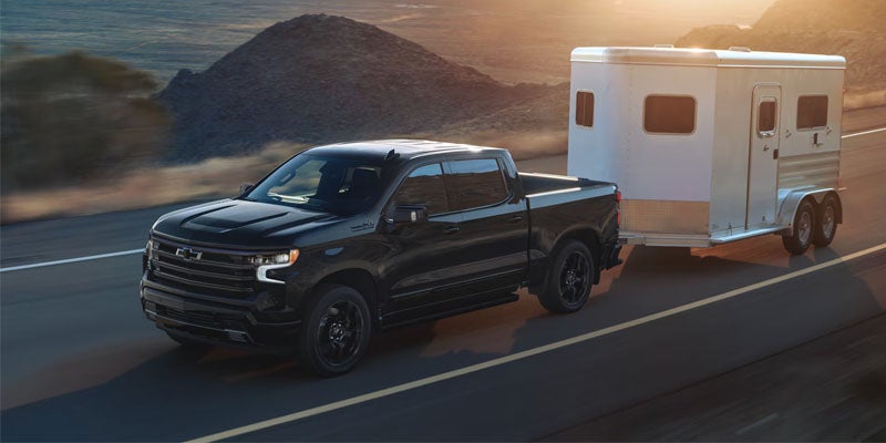 Chevrolet Silverado 1500 towing a small horse trailer