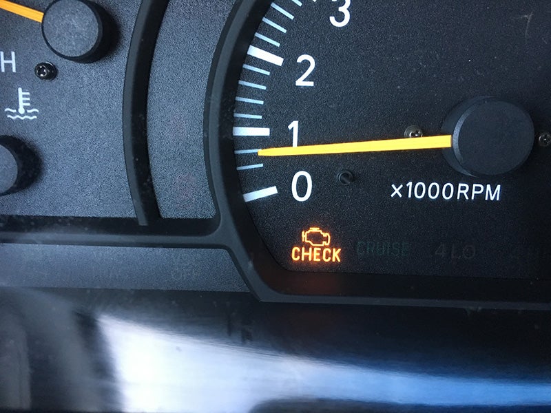 Check engine light warning on a vehicle dashboard